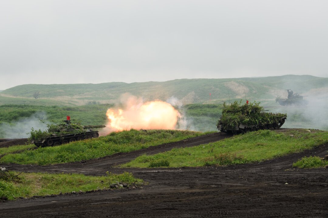 A Japan Self-Defense Forces (JSDF) Type-74 tank fires ammunition during a live fire exercise at the JSDF's training grounds in the East Fuji Maneuver area in Gotemba on May 22, 2021. (Akio Kon/Pool/AFP via Getty Images)