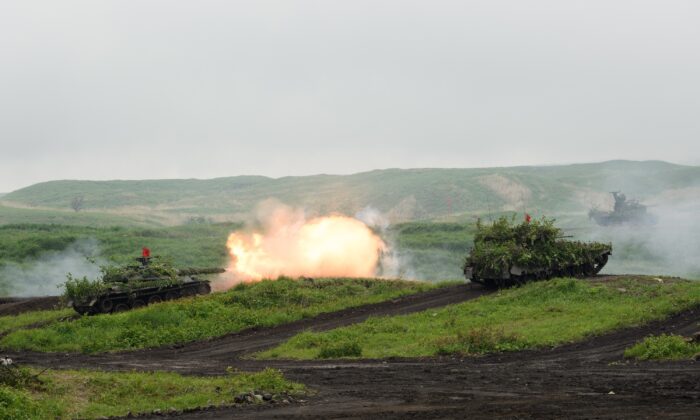 A Japan Self-Defense Forces (JSDF) Type-74 tank fires ammunition during a live fire exercise at the JSDF's training grounds in the East Fuji Maneuver area in Gotemba on May 22, 2021. (Akio Kon/Pool/AFP via Getty Images)