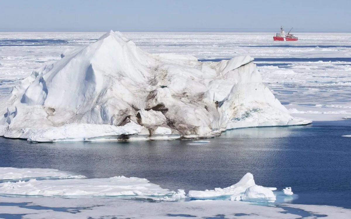 A iceberg floating in the Baffin Bay above the arctic circle dwarfs the Canadian Coast Guard icebreaker Louis S. St-Laurent July 10, 2008. (The Canadian Press/Jonathan Hayward)