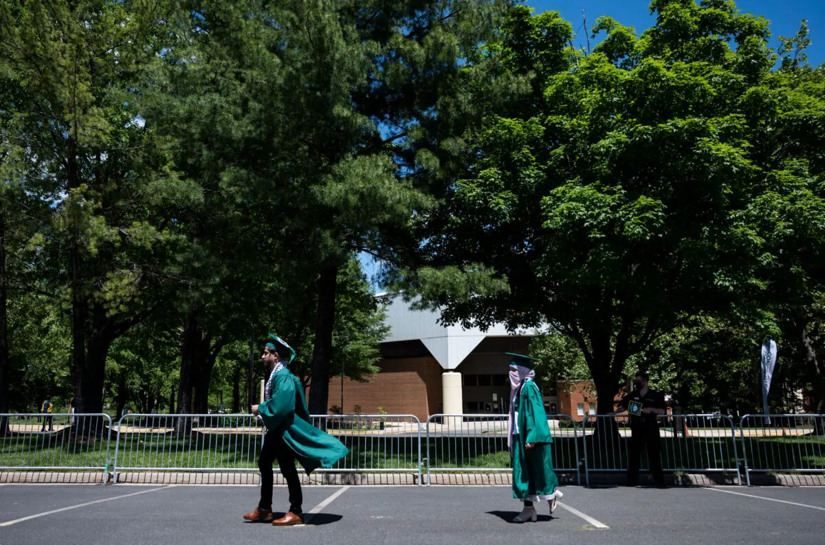 Graduates walk to the stage during a graduation ceremony at George Mason University in Fairfax, Va., on May 13, 2021. (Andrew Caballero-Reynolds/AFP via Getty Images)