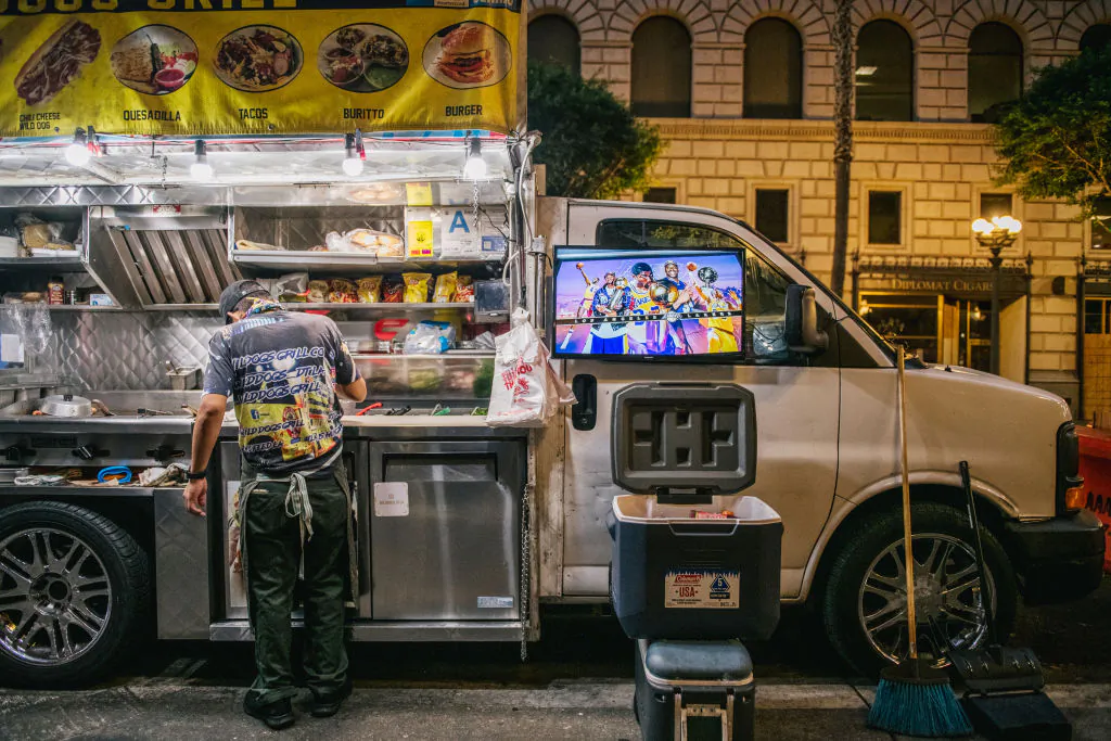 A food truck cooks while displaying the Los Angeles Lakers vs Miami Heat game in Los Angeles on October 11, 2020. (Brandon Bell/Getty Images)