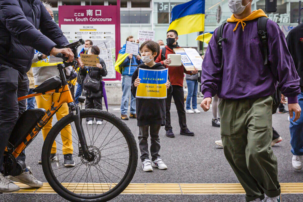 A child holds a placard during a protest against Russia's invasion of Ukraine in front of Shinjuku station in Tokyo, Japan on March 26, 2022. (Yuichi Yamazaki/Getty Images)