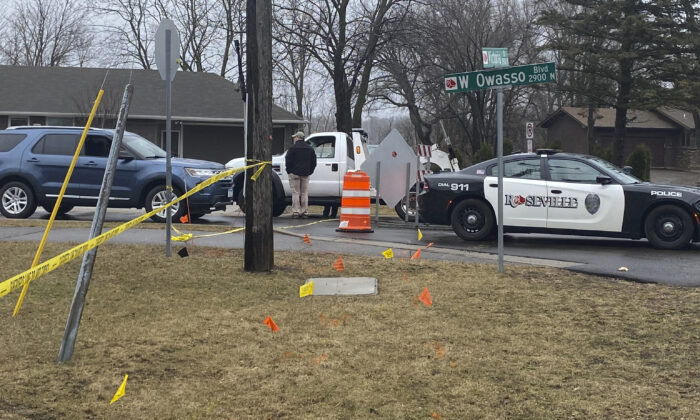 Authorities investigate the scene of a fatal April 5 shooting in Roseville, Minn., on April 6, 2022. (Nick Ferraro/Pioneer Press via AP)