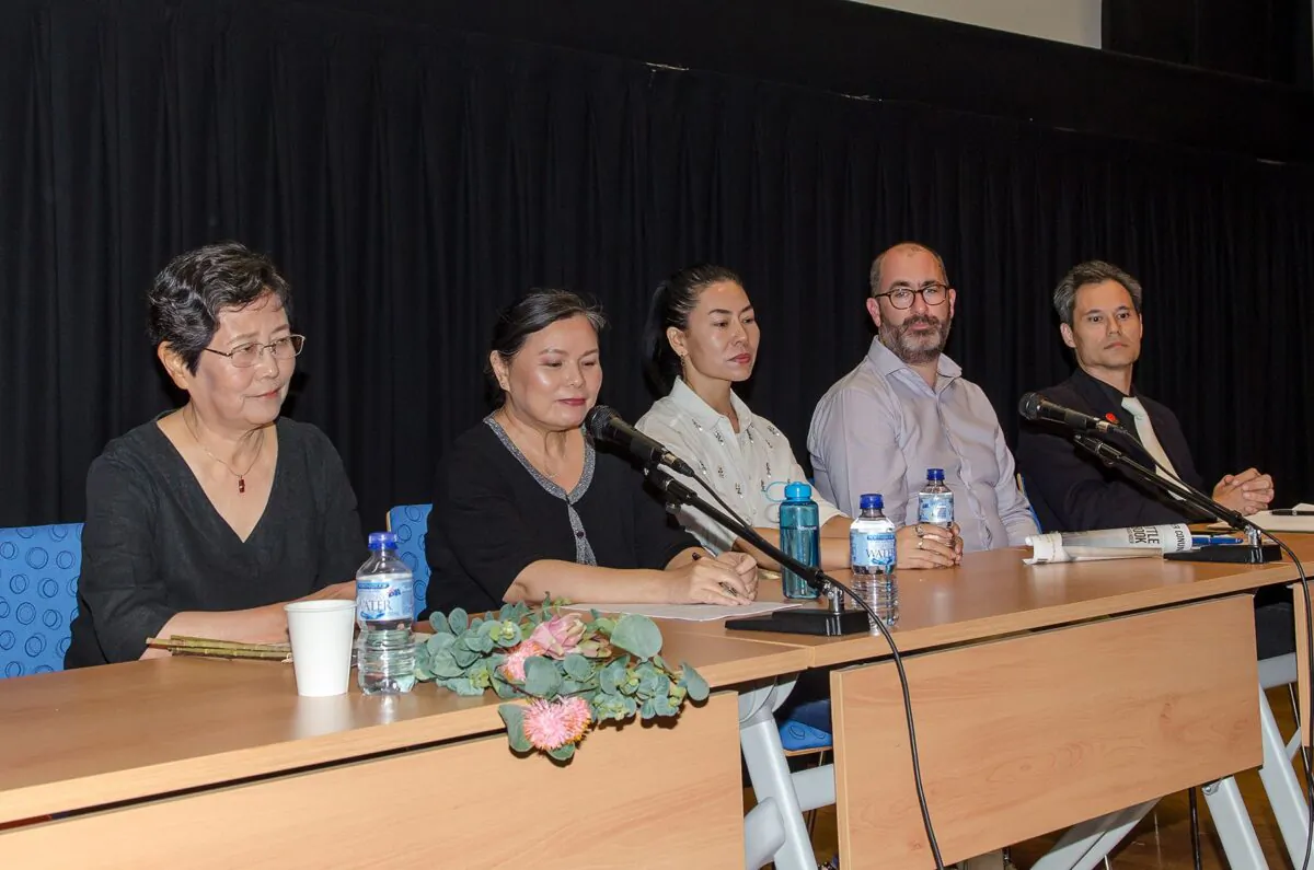 Tian Feng Ying (L) at a panel on forced labor in China following a screening of "Letter from Masanjia," in Perth, Australia, on Dec. 9, 2019. Tian is holding flower decorations similar to the ones she was forced to make while at the Shandong No. 1 Female Labor Camp between 2002 and 2005 in Jinan City, China. (The Epoch Times)