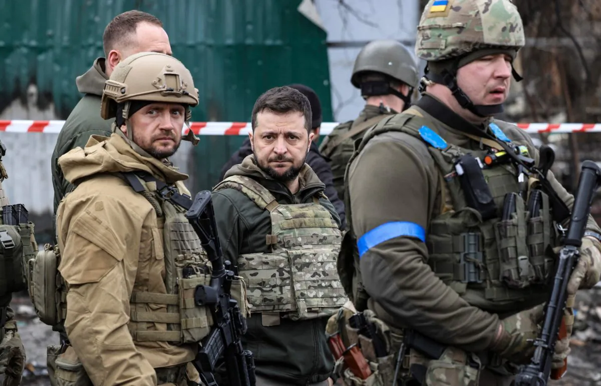 Ukrainian President Volodymyr Zelenskyy (C) in the town of Bucha, northwest of the Ukrainian capital Kyiv, on April 4, 2022. (Ronaldo Schemidt/AFP via Getty Images)