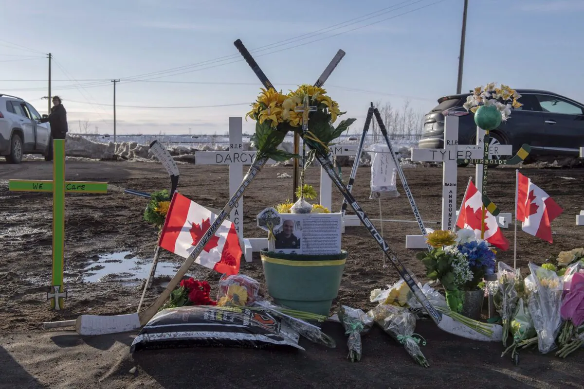 Hockey sticks, messages and other items are seen at a memorial a week after the Humboldt Broncos junior hockey team bus and a transport truck collided at an intersection near Tisdale, Sask. on April 6, 2018. (The Canadian Press/Liam Richards)