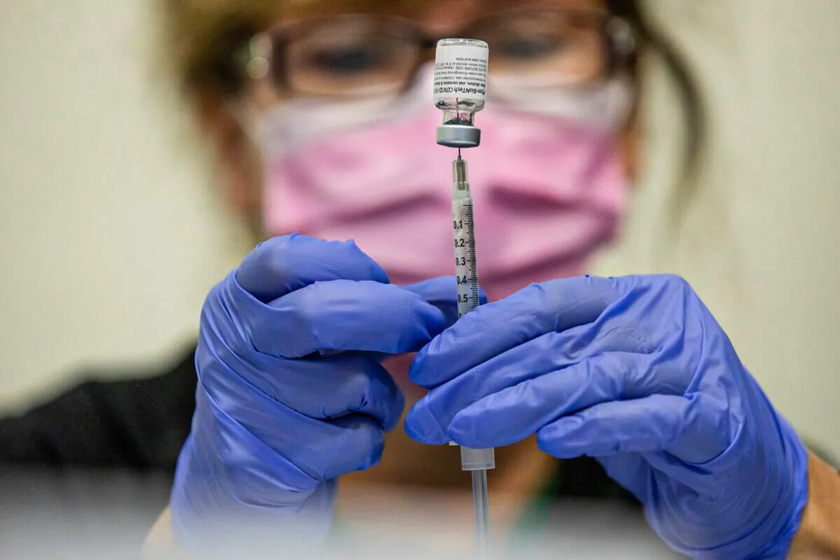 A nurse prepares a COVID-19 vaccine in Southfield, Mich., on Sept. 29, 2021. (Emily Elconin/Reuters)