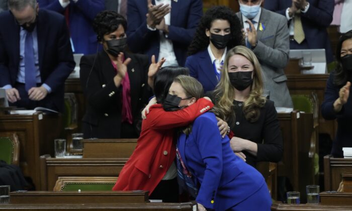 Finance Minister Chrystia Freeland receives a hug after tabling the federal budget in the House of Commons in Ottawa on April 7, 2022. (Adrian Wyld/The Canadian Press)