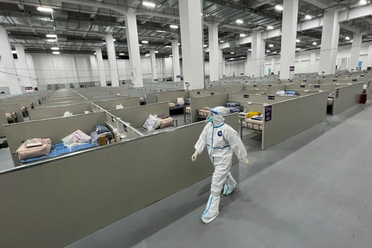 A staff member walks inside a makeshift hospital that will be used for COVID-19 patients in eastern China’s Shanghai on April 7, 2022. (STR/AFP via Getty Images)