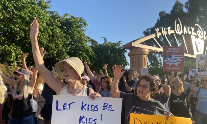 Protestors rally in opposition to The Walt Disney Co.'s stance against a recently passed Florida law outside of the company's headquarters in Burbank, Calif., on April 6, 2022. (Jill McLaughlin/The Epoch Times)