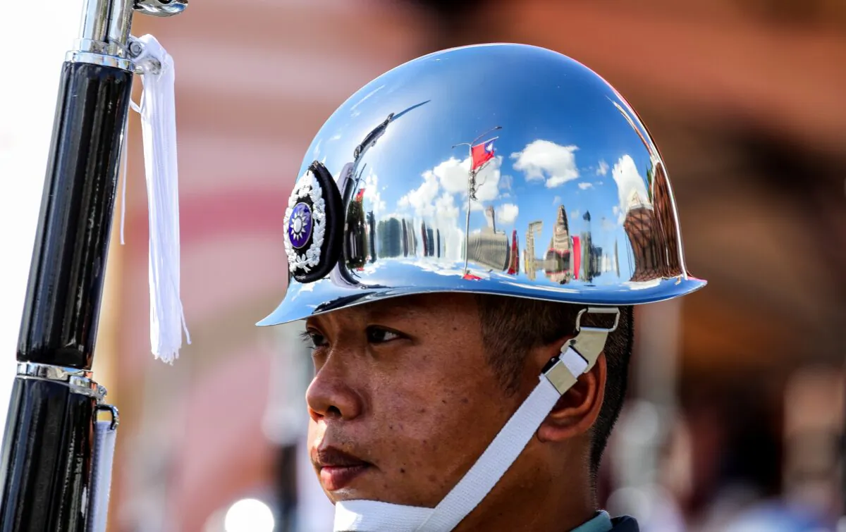 A Taiwanese flag is reflected on the helmet of one of the Ministry of National Defense Honor Guards during the National Day celebration in Taipei, Taiwan, on Oct. 10, 2021. Taiwan President Tsai Ing-Wen said the island is facing unprecedented challenges and will defend its sovereignty, pushing back after Chinese leader Xi Jinping declared a day earlier that unification will be achieved. (I-Hwa Cheng/Bloomberg via Getty Images)