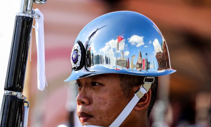 A Taiwanese flag is reflected on the helmet of one of the Ministry of National Defense Honor Guards during the National Day celebration in Taipei, Taiwan, on Oct. 10, 2021. Taiwan President Tsai Ing-Wen said the island is facing unprecedented challenges and will defend its sovereignty, pushing back after Chinese leader Xi Jinping declared a day earlier that unification will be achieved. (I-Hwa Cheng/Bloomberg via Getty Images)