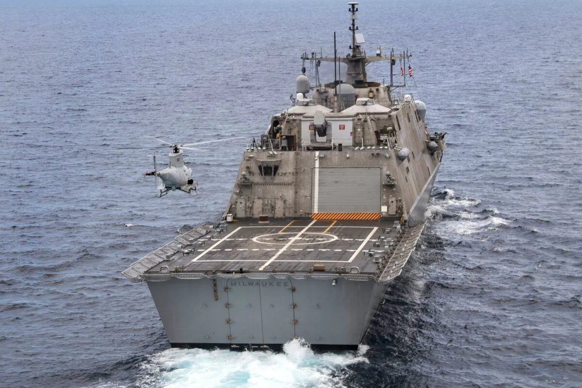 The USS Milwaukee, a Freedom-class of littoral combat ship, cruises underway as an MQ-8B Fire Scout unmanned aerial vehicle hovers during flight operations in the Atlantic Ocean, on June 27, 2019. (Mass Communication Specialist 2nd Class Anderson W. Branch/U.S. Navy via AP)