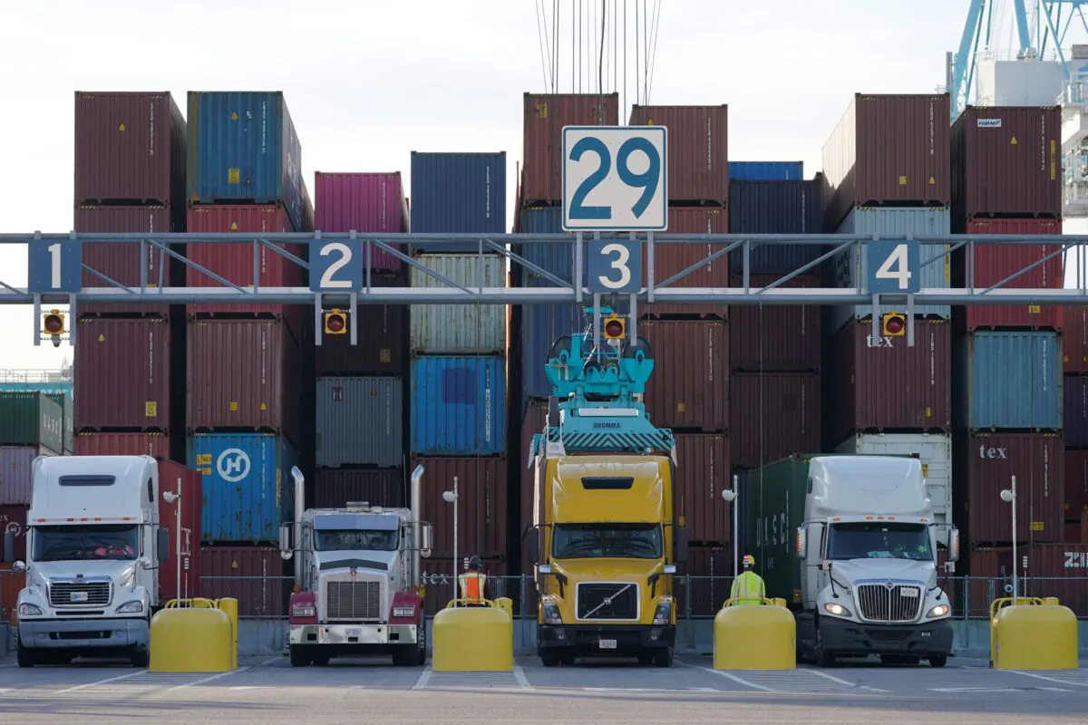 Trucks line up to have containers loaded from a stack at the Norfolk International Terminal in Norfolk, Va., on Dec 1, 2021. (Steve Helber/AP Photo)