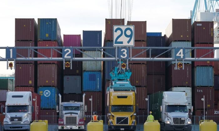 Trucks line up to have containers loaded from a stack at the Norfolk International Terminal in Norfolk, Va., on Dec 1, 2021. (Steve Helber/AP Photo)
