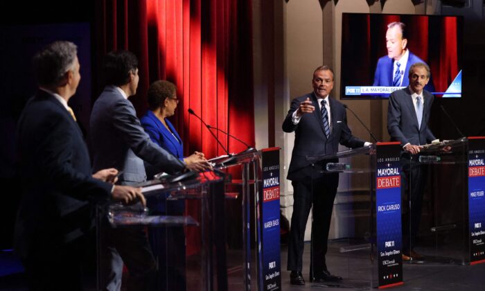 Rick Caruso (2nd R) makes a rebuttal during the mayoral debate with candidates (from L) Joe Buscaino, Kevin de Leon, Karen Bass and Mike Feuer at USC's Bovard Auditorium in Los Angeles on March 22, 2022. (Myung J. Chun/Pool/AFP via Getty Images)