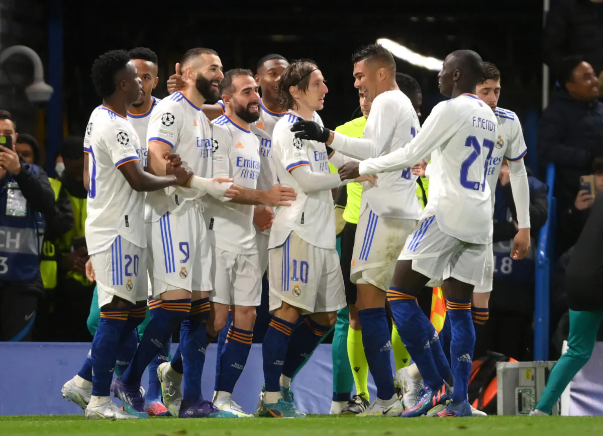 Karim Benzema of Real Madrid celebrates with teammates after scoring their team's third goal and their hat trick during the UEFA Champions League Quarter Final Leg One match between Chelsea FC and Real Madrid at Stamford Bridge, in London, on April 6, 2022. (Mike Hewitt/Getty Images)
