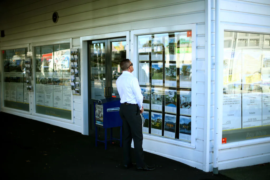 Housing for sale is displayed on an real estate office shop window in Auckland, New Zealand, on May 13, 2014. (Phil Walter/Getty Images)
