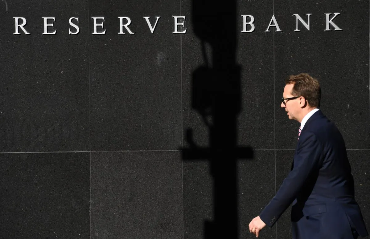A man walks past the Reserve Bank of Australia sign in Sydney, Australia, on Sep. 6, 2016. (William West/AFP via Getty Images)