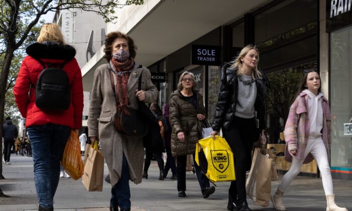 Members of the public walk along Oxford Street in London on April 1, 2022. (Dan Kitwood/Getty Images)