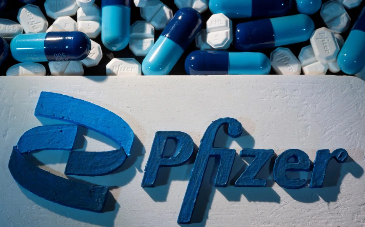 A 3D printed Pfizer logo is placed near medicines in an illustration taken on Sept. 29, 2021. (Dado Ruvic/Reuters)