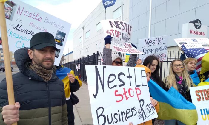 The large Ukrainian community in Ohio is protesting against Nestle continuing to do business in Russia. It is  urging a boycott of the global food and candy manufacturer. About 30 people including Zenon Chaikovsky (L)  protested in front of the Nestle plant in west Cleveland on April 7. (Michael Sakal/The Epoch Times)  
