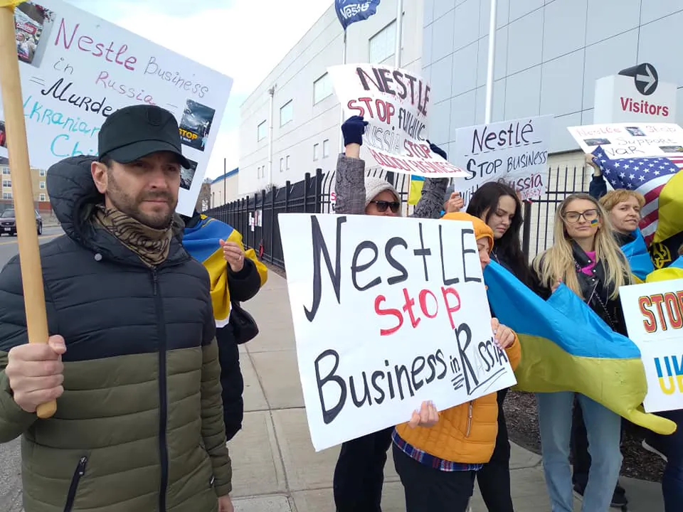 The large Ukrainian community in Ohio is protesting against Nestle continuing to do business in Russia. It is  urging a boycott of the global food and candy manufacturer. About 30 people including Zenon Chaikovsky (L)  protested in front of the Nestle plant in west Cleveland on April 7. (Michael Sakal/The Epoch Times)  