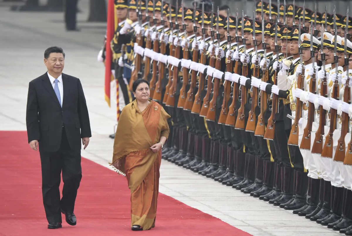 Nepal's President Bidhya Devi Bhandar (front right) and Chinese leader Xi Jinping review honor guards during a welcome ceremony at the Great Hall of the People in Beijing, China, on April 29, 2019. (Madoka Ikegami/Pool/Getty Images)