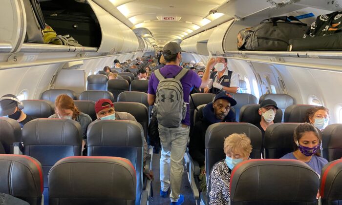 Passengers board an American Airlines flight in New York to Charlotte, N.C., on May 3, 2020. (Eleonore Sens/AFP via Getty Images)