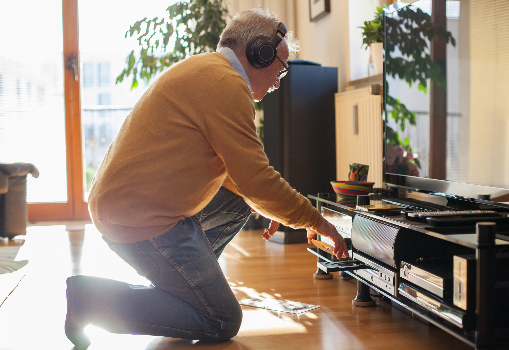 Senior man listening to music at home