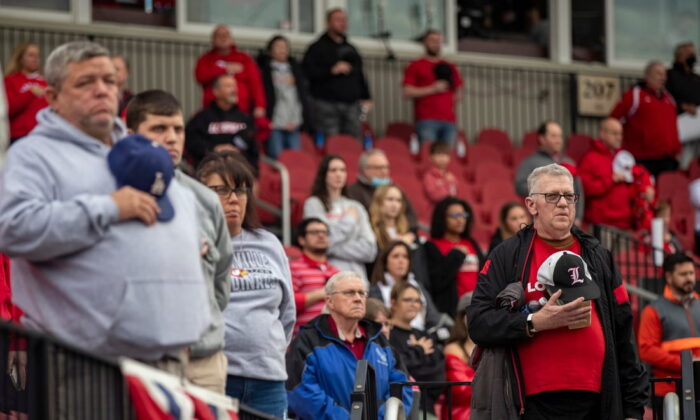 Fans stand for the National Anthem before the Louisville Cardinals took on Xavier at Jim Patterson Stadium in Louisville, Ky., on Feb. 21, 2022. (Alton Strupp/Courier Journal/ USA TODAY NETWORK via Field Level Media)