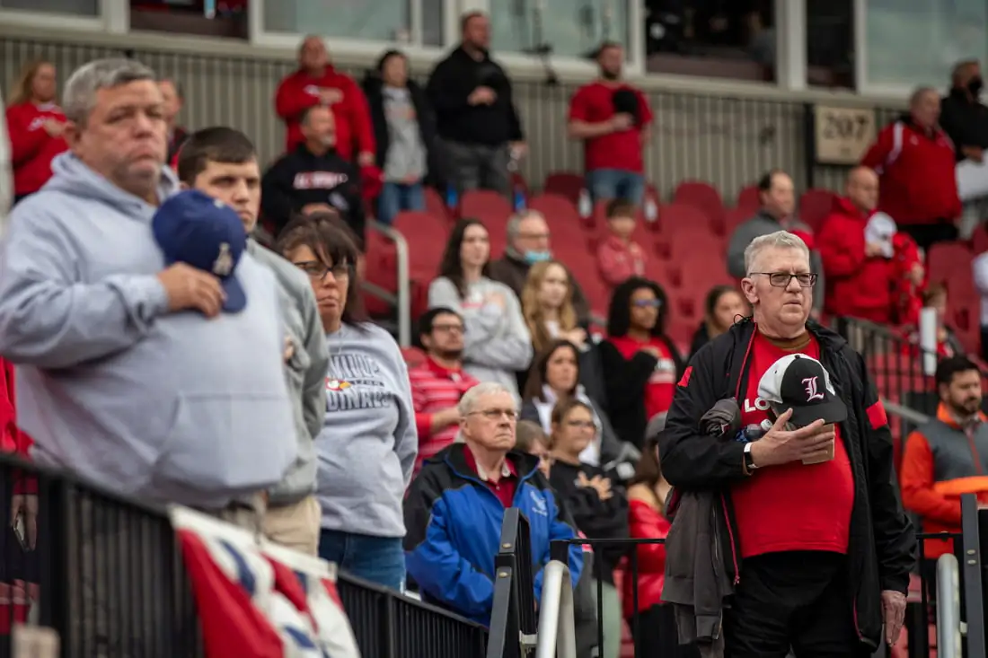 Fans stand for the National Anthem before the Louisville Cardinals took on Xavier at Jim Patterson Stadium in Louisville, Ky., on Feb. 21, 2022. (Alton Strupp/Courier Journal/ USA TODAY NETWORK via Field Level Media)
