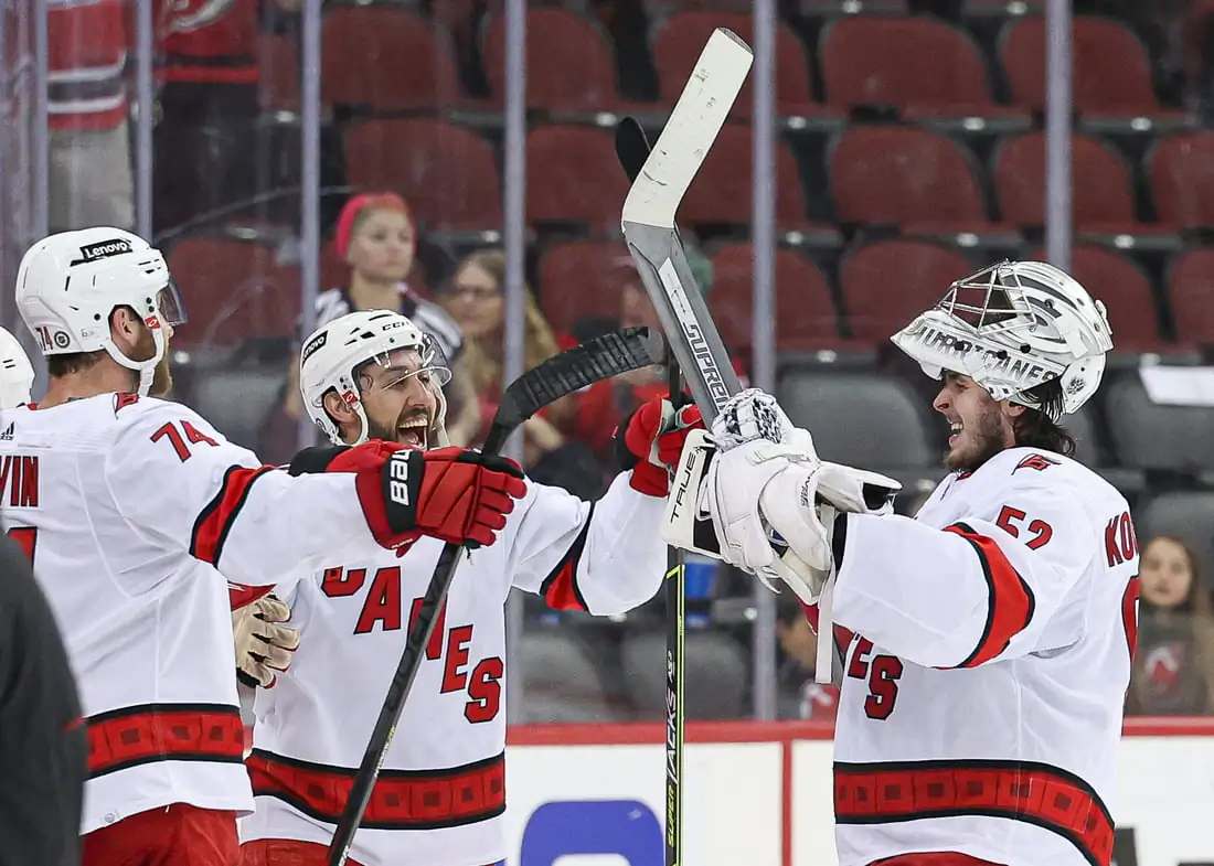 Carolina Hurricanes goaltender Pyotr Kochetkov (52) celebrates with defenseman Jaccob Slavin (74) and center Vincent Trocheck (16) after an overtime victory against the New Jersey Devils at Prudential Center, in Newark, N.J., on April 23, 2022. (Vincent Carchietta/USA TODAY Sports via Field Level Media)