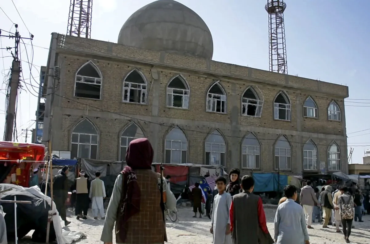 A Taliban fighter standing guard outside the site of a bomb explosion inside a mosque, in Mazar-e-Sharif province, Afghanistan, on April 21, 2022. (AP Photo)