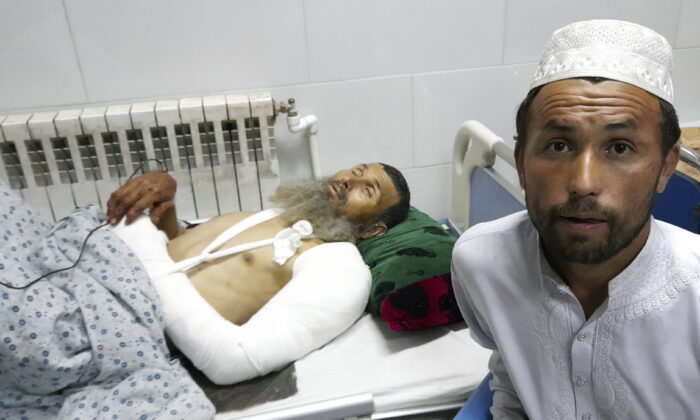 A wounded man receives treatment in a hospital, after a bombing at a mosque in the town of Imam Saheb, in Kunduz Province in north of Kabul, Afghanistan, on April 22, 2022. (Abdullah Sahil/(AP Photo)