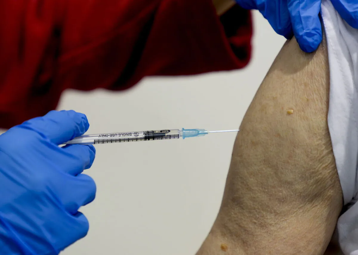A 87-year-old man getting his booster shot at the vaccination center in Frankfurt, Germany, on Nov. 11, 2021. (Michael Probst/AP Photo)