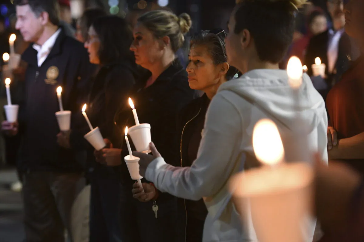 People attend a candlelight vigil for victims of a fatal shooting held at Ali Youssefi Square in Sacramento, Calif., on April 4, 2022. (Jose Carlos Fajardo/Bay Area News Group via AP)