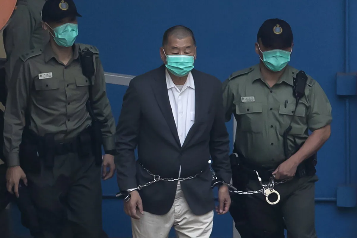 Hong Kong media mogul and pro-democracy activist Jimmy Lai is escorted to a prison van before appearing in court in Hong Kong on Dec. 12, 2020. (Kin Cheung/AP Photo)