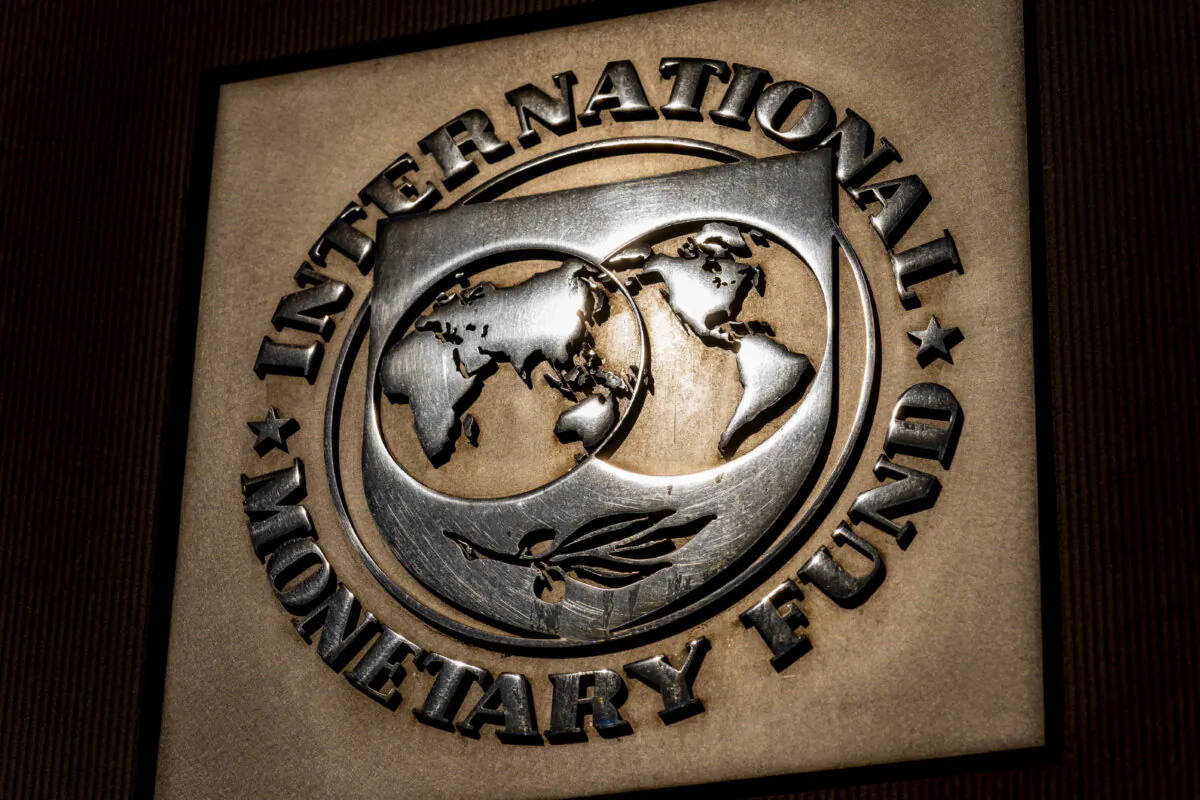 FILE - The logo of the International Monetary Fund is visible on their building, April 5, 2021, in Washington. The International Monetary Fund downgraded the outlook for the world economy this year and next, blaming the Ukraine war for disrupting global commerce, pushing up oil prices, threatening food supplies and increasing uncertainty already heightened by COVID-19 and its variants.(AP Photo/Andrew Harnik)