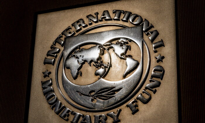 FILE - The logo of the International Monetary Fund is visible on their building, April 5, 2021, in Washington. The International Monetary Fund downgraded the outlook for the world economy this year and next, blaming the Ukraine war for disrupting global commerce, pushing up oil prices, threatening food supplies and increasing uncertainty already heightened by COVID-19 and its variants.(AP Photo/Andrew Harnik)
