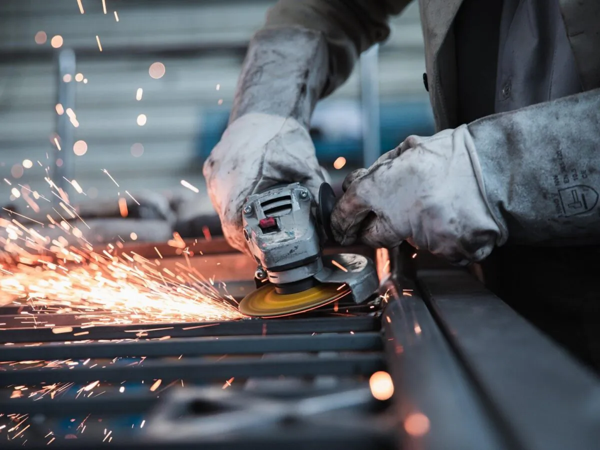 Stock photo of a person operating a sanding machine. (jannonivergall via Pixabay)