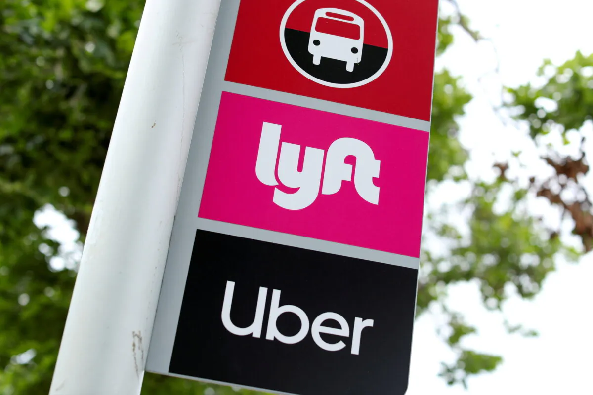 A sign marks a location for Lyft and Uber users at San Diego State University in San Diego, Calif., on May 13, 2020. (Mike Blake/Reuters)