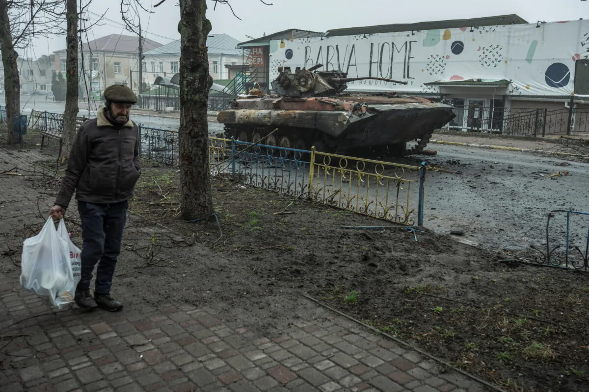 A local man walks past a damaged armored personal carrier, as Russia's attack on Ukraine continues, in the town of Makariv, in Kyiv region, Ukraine, on April 1, 2022. (Serhii Mykhalchuk/Reuters)