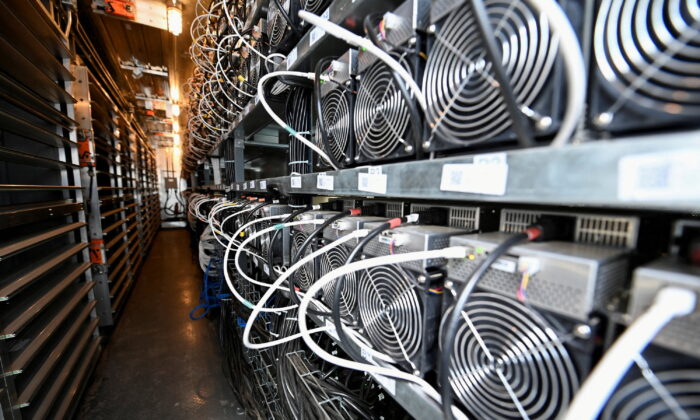 A bank of cryptocurrency miners operates at the Scrubgrass Plant in Kennerdale, Pennsylvania, on March 8, 2022. (Alan Freed/Reuters)