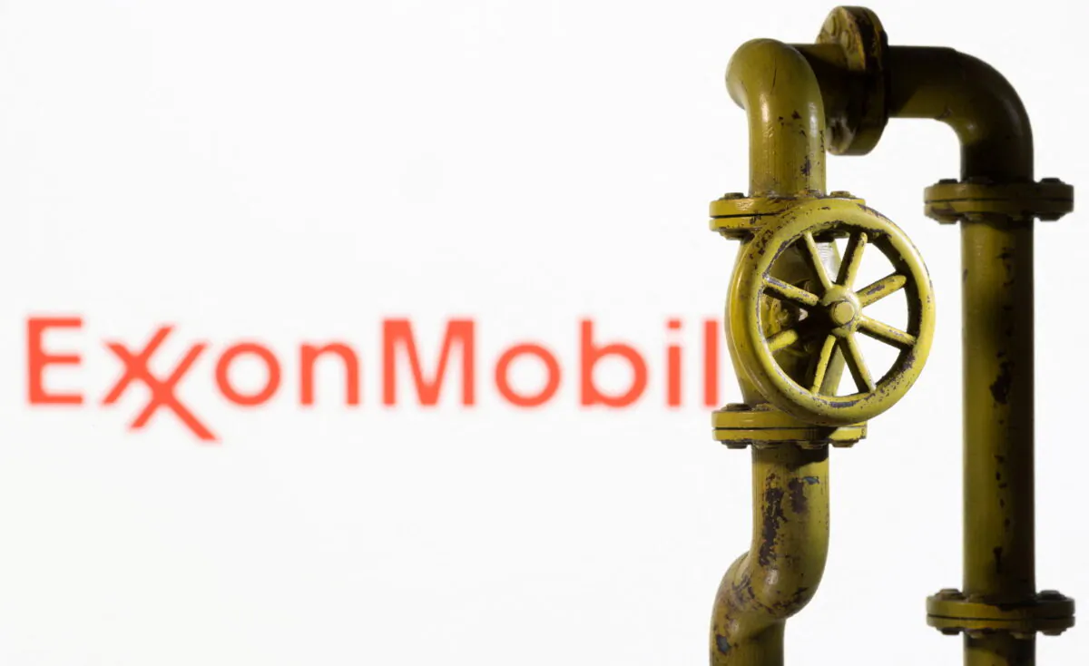 A 3D printed natural gas pipeline is placed in front of displayed ExxonMobil logo in this illustration taken on Feb. 8, 2022. (Dado Ruvic/Illustration/Reuters)