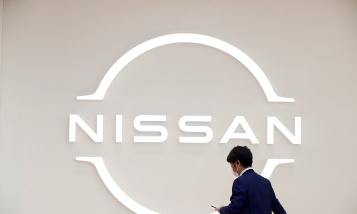 A man walks in front of the Nissan logo at Nissan Gallery in Yokohama, Japan on Nov. 29, 2021. (Androniki Christodoulou/Reuters)