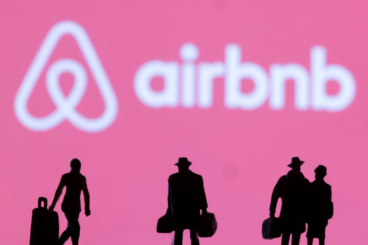 Figurines are seen in front of the Airbnb logo in this illustration taken Feb. 27, 2022. (Dado Ruvic/Illustration/Reuters)