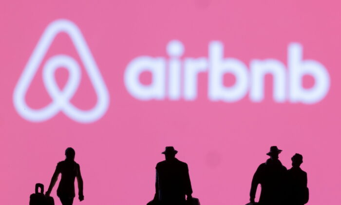 Figurines are seen in front of the Airbnb logo in this illustration taken Feb. 27, 2022. (Dado Ruvic/Illustration/Reuters)