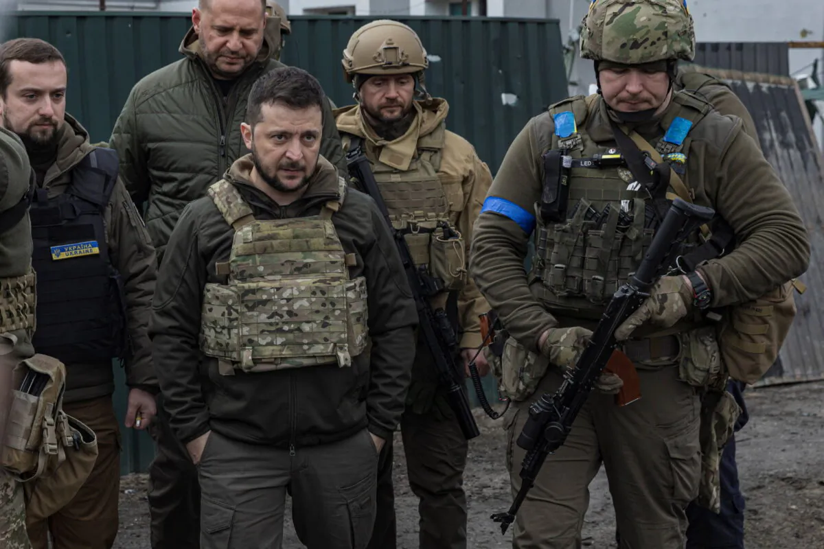 Ukraine's President Volodymyr Zelenskyy looks on as he is surrounded by Ukrainian servicemen as Russia's invasion of Ukraine continues, in Bucha, outside Kyiv, Ukraine, April 4, 2022. (Marko Djurica/file/Reuters)