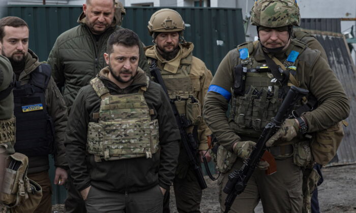 Ukraine's President Volodymyr Zelenskyy looks on as he is surrounded by Ukrainian servicemen as Russia's invasion of Ukraine continues, in Bucha, outside Kyiv, Ukraine, April 4, 2022. (Marko Djurica/file/Reuters)